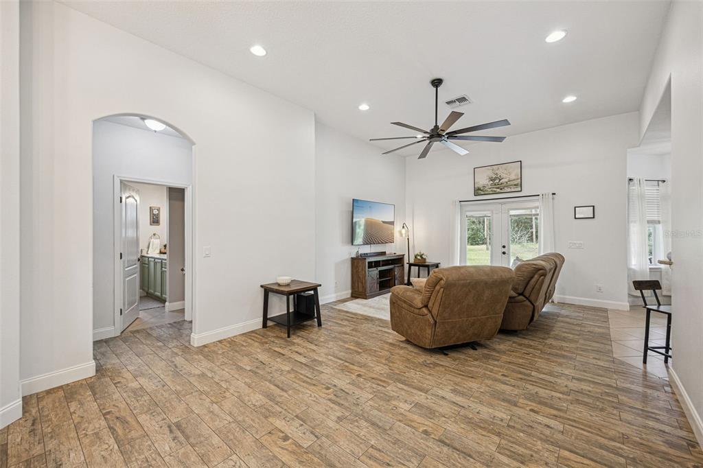 A dining room with a wooden table and chairs is visible through an arched entryway — 41220 ALDER WAY, EUSTIS, FL