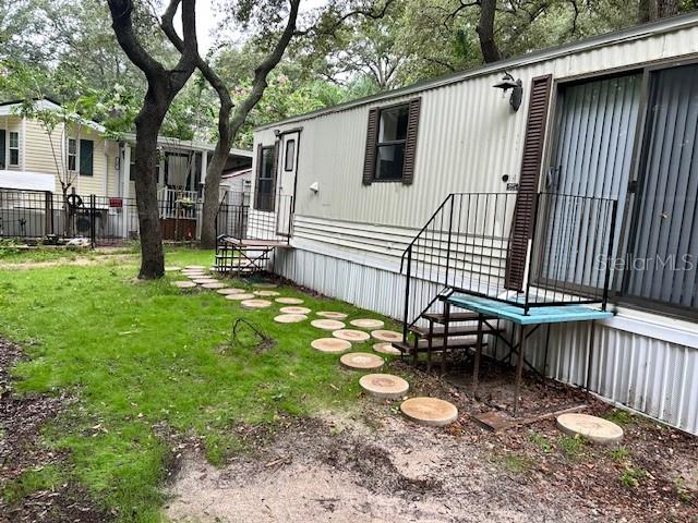 A mobile home exterior features a metal staircase leading to a door and sliding windows — 3000 CLARCONA ROAD UNIT 823, APOPKA, FL