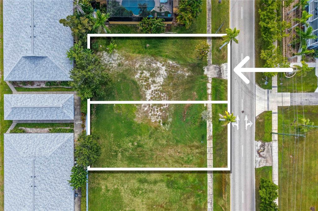 An aerial view shows two adjacent vacant rectangular lots bordered by a road and buildings — 821 W MARION AVENUE, PUNTA GORDA, FL