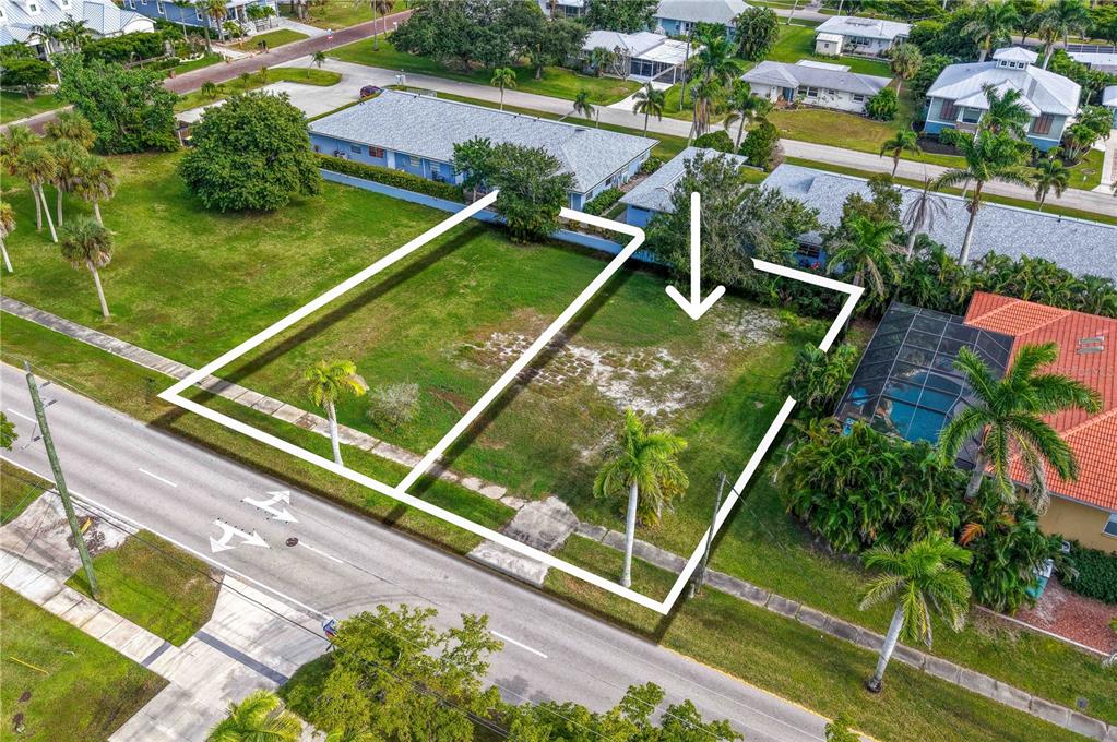 An aerial view shows two adjacent vacant residential lots outlined in white along a street — 821 W MARION AVENUE, PUNTA GORDA, FL