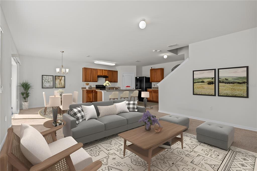 An open-concept living room and kitchen featuring a grey sofa, dining area, and wooden cabinetry — 817 SHEEN CIRCLE, HAINES CITY, FL