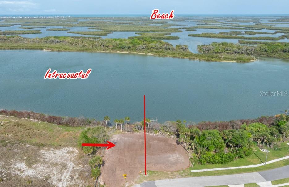 An aerial view shows a cleared waterfront lot with a red line indicating property boundaries — 183 JONES FISH CAMP ROAD, EDGEWATER, FL