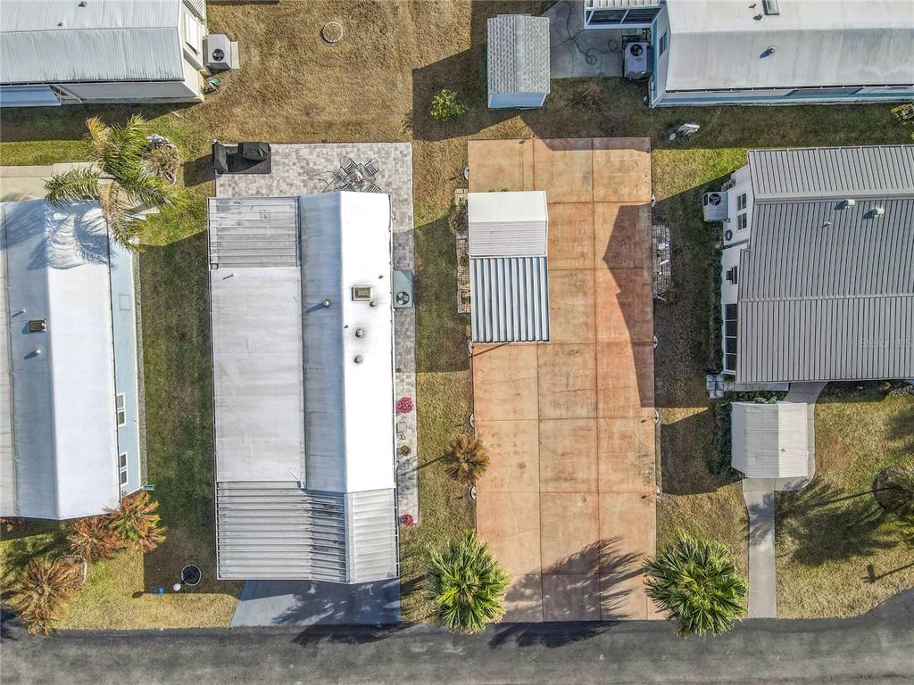 An aerial view shows two mobile homes with a shared concrete driveway and palm trees — 450 PINE LOOP, FROSTPROOF, FL