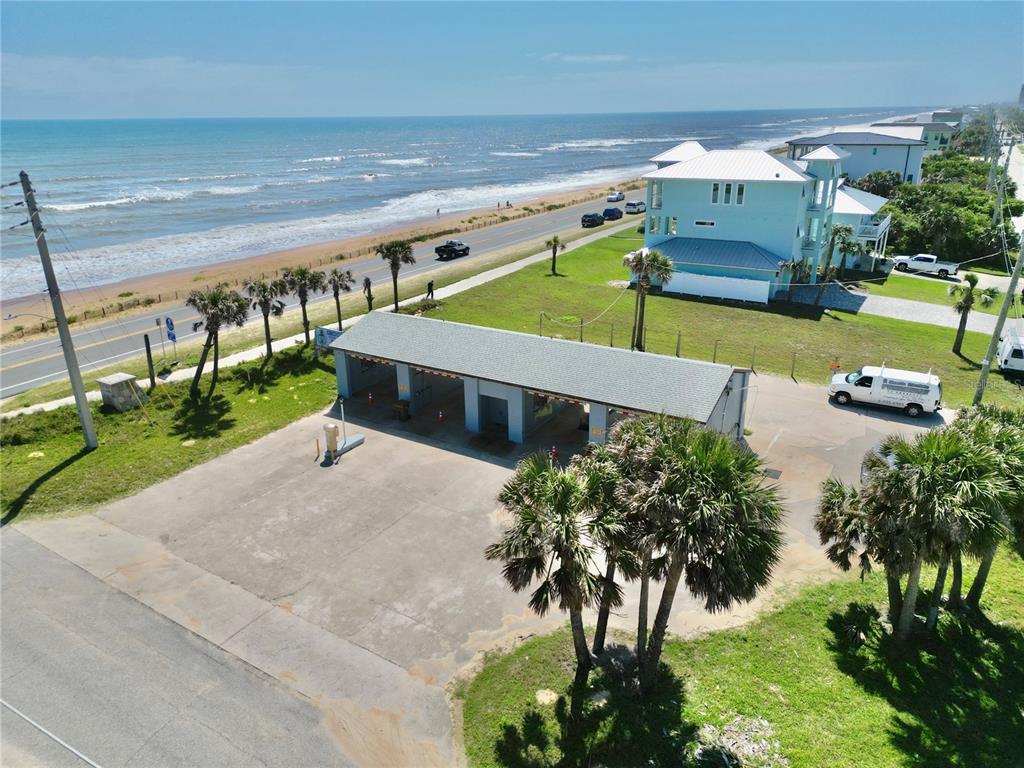 An aerial view shows a car wash structure located near a beach and coastal road — 2299 N OCEANSHORE BOULEVARD, FLAGLER BEACH, FL