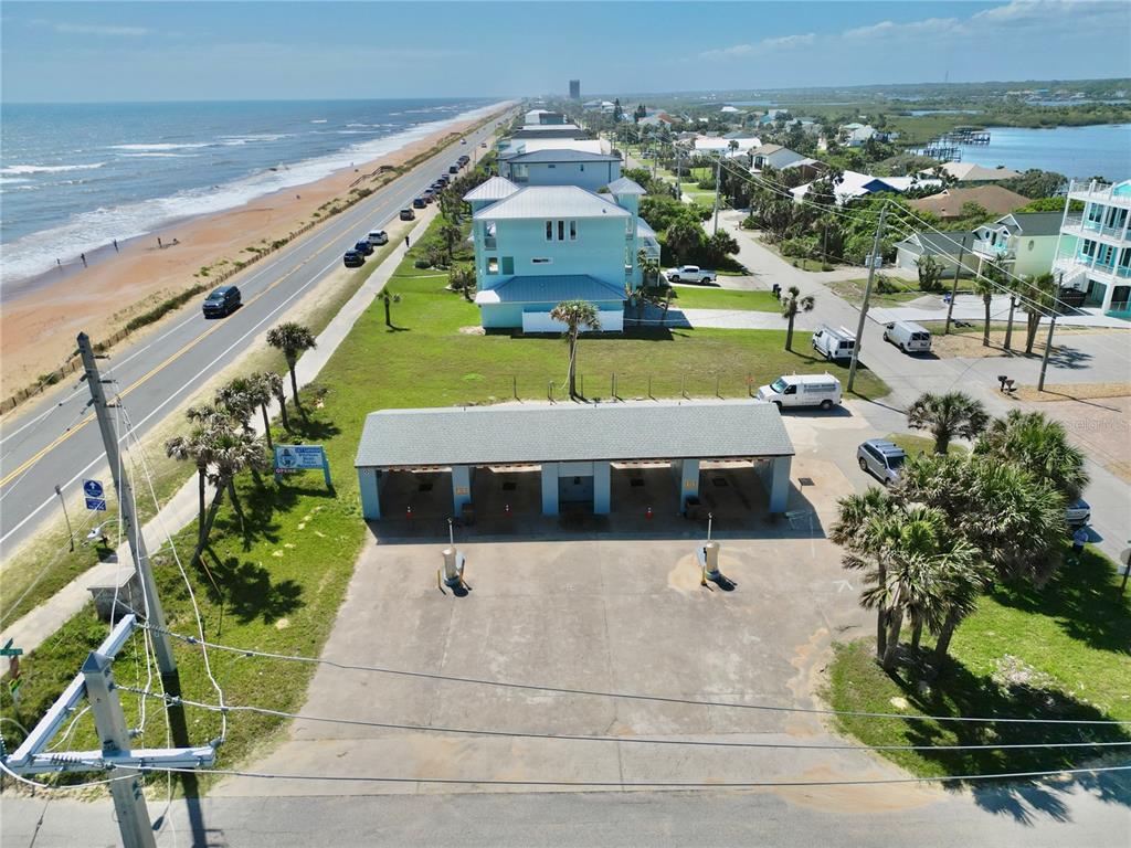 An aerial view shows a car wash facility located near a coastal road and beach — 2299 N OCEANSHORE BOULEVARD, FLAGLER BEACH, FL