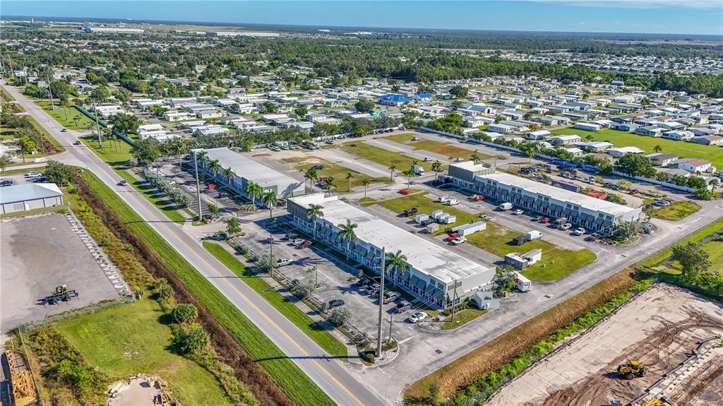 An aerial view shows commercial buildings, parking lots, and surrounding residential areas — 6640 TAYLOR ROAD UNIT B, PUNTA GORDA, FL