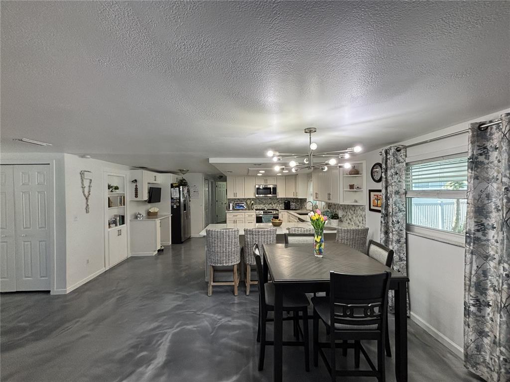 A living room features a large gray sectional sofa, a shaggy rug, and blue walls — 1002 SILVER PALM WAY, APOLLO BEACH, FL