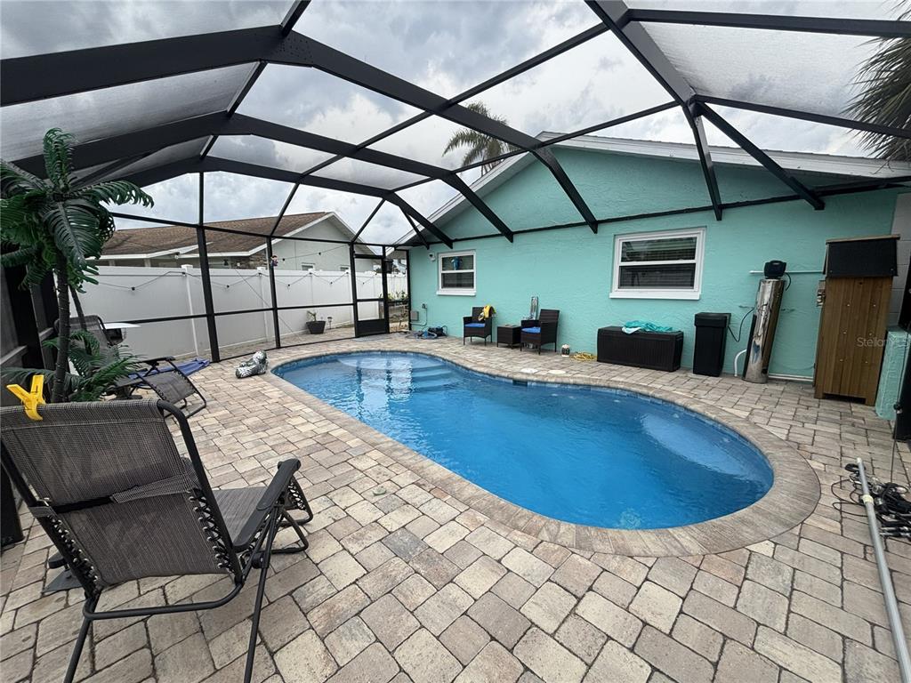 A spacious open-concept living room and kitchen featuring gray flooring and a large area rug — 1002 SILVER PALM WAY, APOLLO BEACH, FL