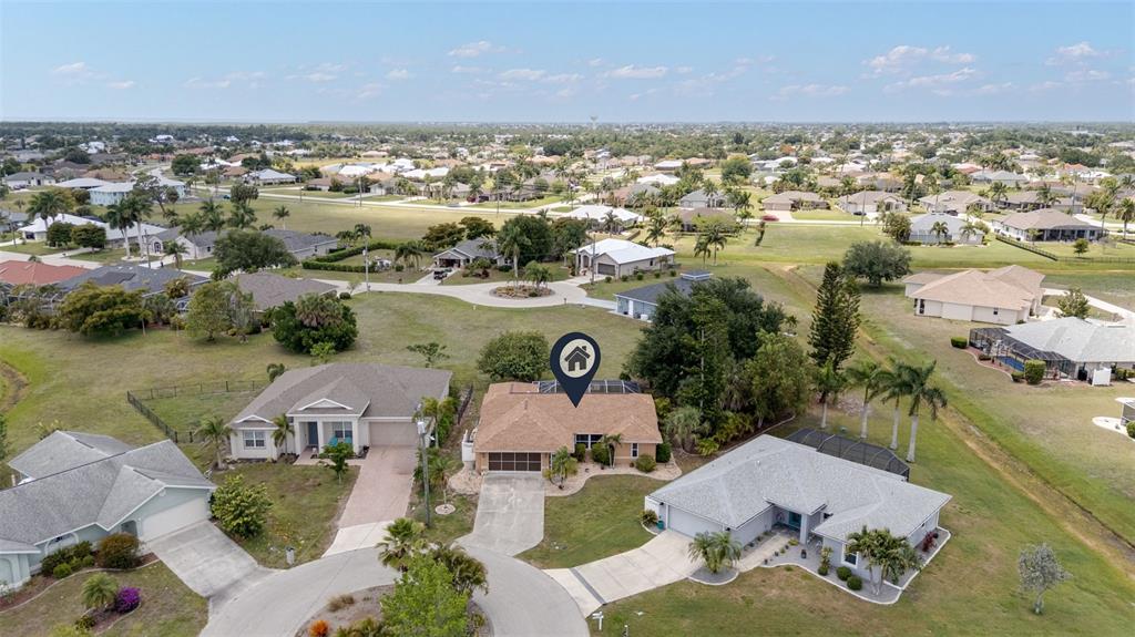 An aerial view shows a suburban neighborhood with a single-story house marked by a pin — 154 ACALYPHA, PUNTA GORDA, FL