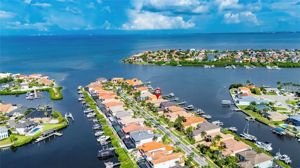 This aerial view shows a waterfront residential neighborhood with docks and boats along a canal — 1231 ACAPPELLA LANE, APOLLO BEACH, FL