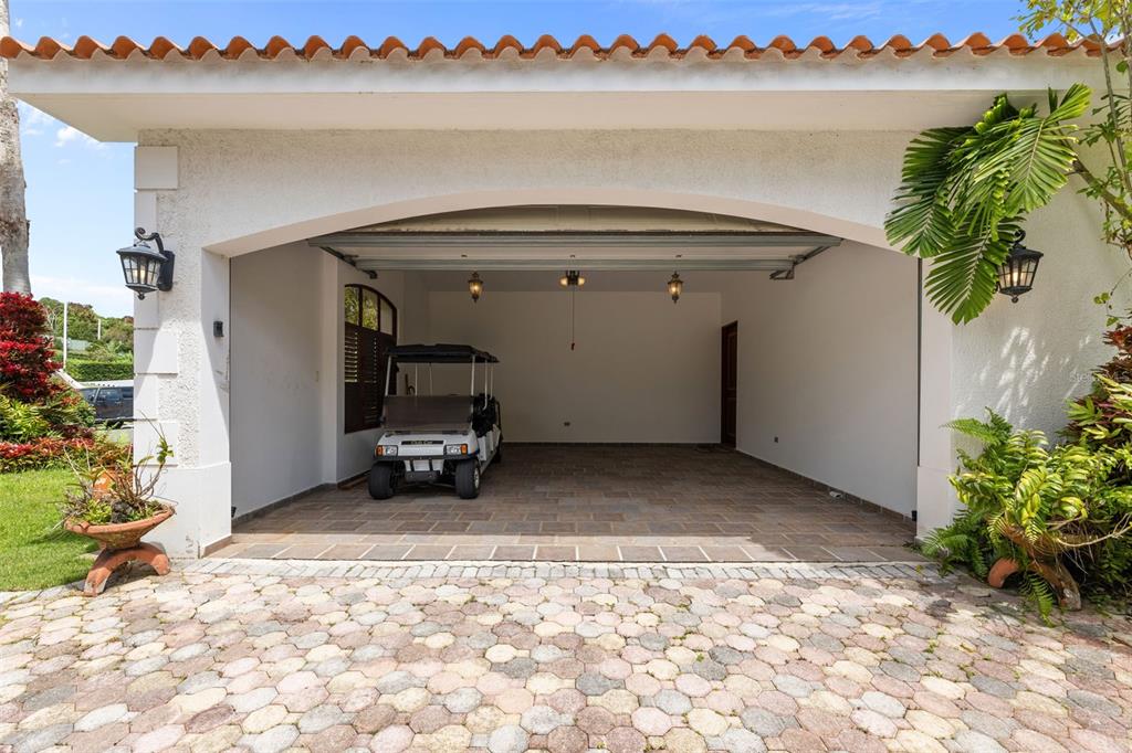 An open-air garage with a tiled floor, a golf cart, and a terracotta roof — Las Vistas 36,  Rio Mar MIRADOR, 36, RIO MAR, RIO GRANDE, PR
