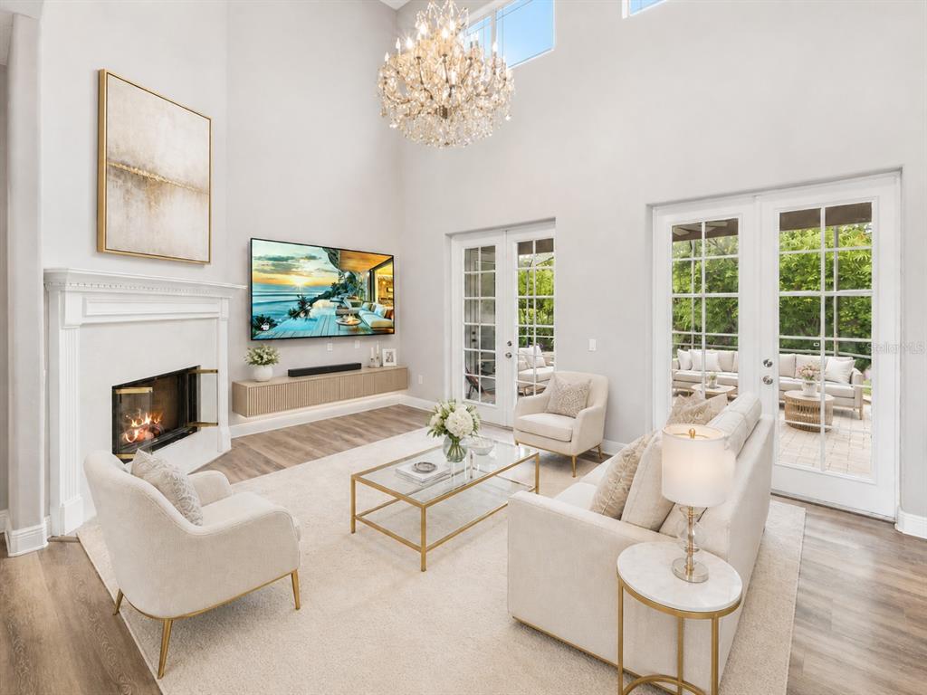 A modern kitchen features white cabinets, stainless steel appliances, and an adjacent dining area — 10370 TROUT ROAD, ORLANDO, FL