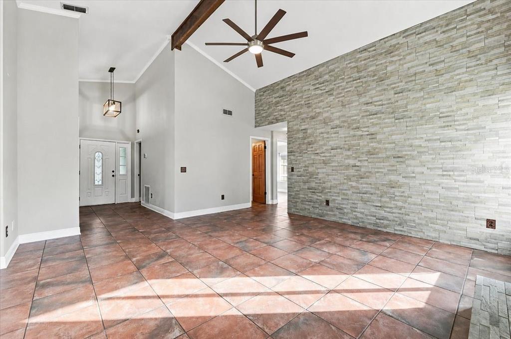 A light green house exterior features a white garage door and a screened-in entryway — 20828 MAXIM PARKWAY, ORLANDO, FL