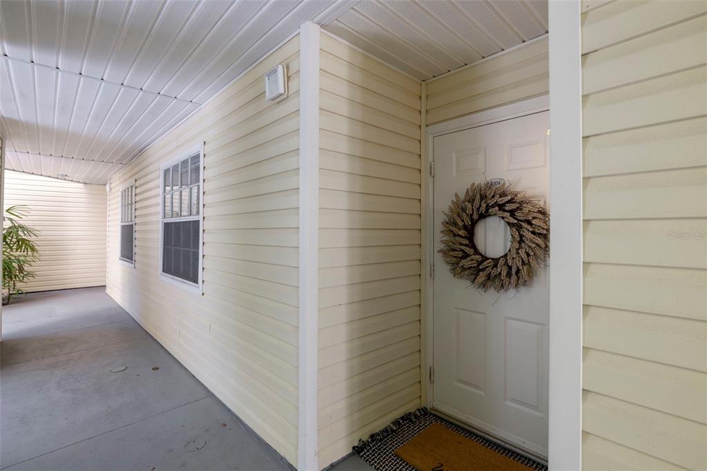An exterior view of a multi-story townhouse complex with a canal and a small bridge — 6915 STONES THROW CIRCLE N UNIT 3104, ST PETERSBURG, FL