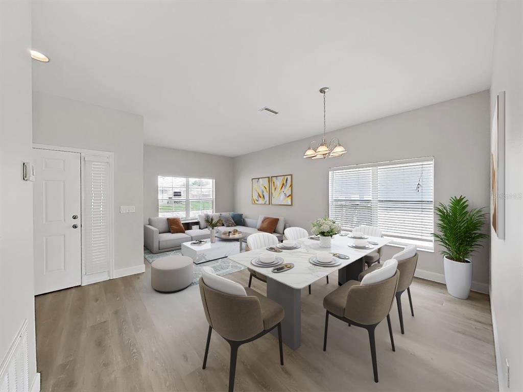 This is a virtual staging of an open-concept living and dining room with light flooring — 11908 FERN BLOSSOM DRIVE, GIBSONTON, FL