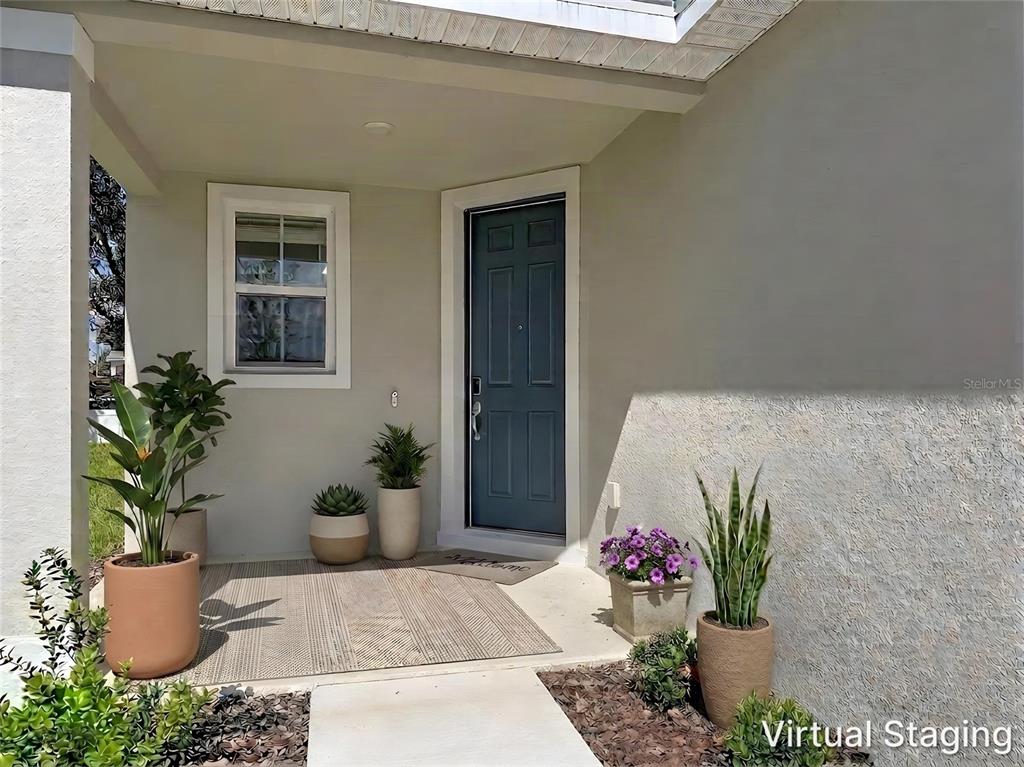 An empty room with white walls, tile flooring, a window, and sliding glass patio doors — 770 LAKE DELL AVENUE, DUNDEE, FL