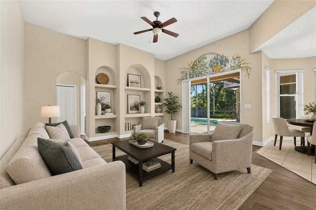A living room features beige walls, built-in arched shelving, a ceiling fan, and sliding glass doors — 1200 ALBERTA STREET, LONGWOOD, FL