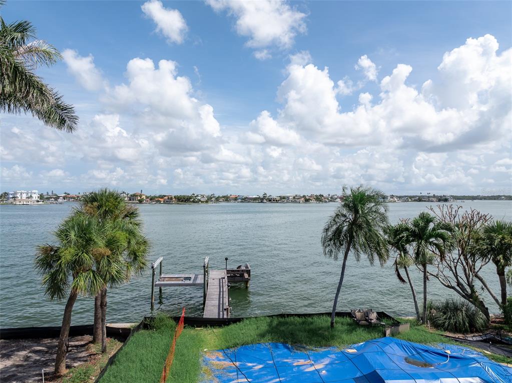 An aerial view shows a bridge connecting waterfront properties and residential islands in a bay — 2 PARADISE LANE, TREASURE ISLAND, FL