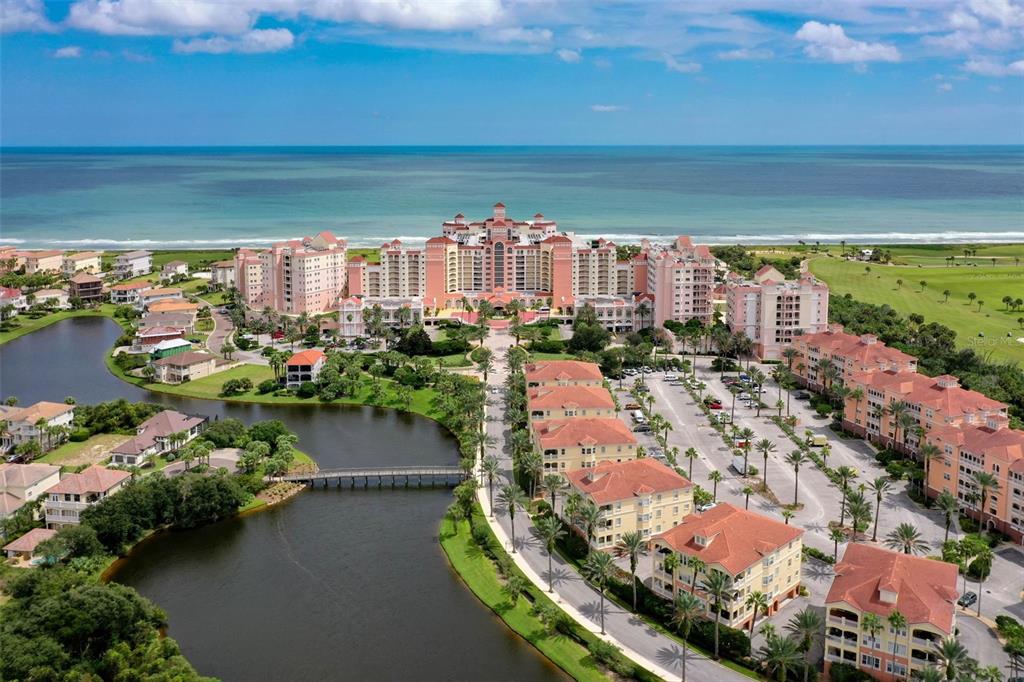 An aerial view of a large coastal resort complex with multiple buildings, pools, and surrounding greenery — 15 OCEAN CREST WAY UNIT 1342, PALM COAST, FL