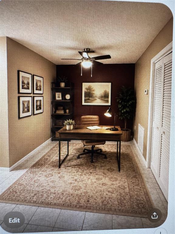A room with light-colored tile flooring transitions to dark wood flooring near a sliding door — 511 LONGFELLOW COURT UNIT B, SAFETY HARBOR, FL