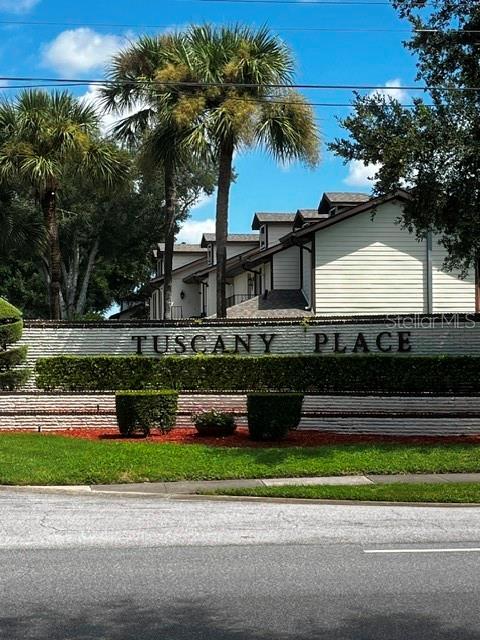 The exterior of a residential complex features a sign reading Tuscany Place with palm trees — 600 NORTHERN WAY UNIT 1108, WINTER SPRINGS, FL
