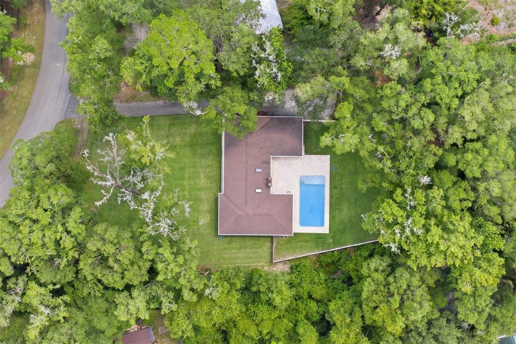 An aerial view shows a house with a brown roof and a rectangular swimming pool — 226 SW 80TH BOULEVARD, GAINESVILLE, FL