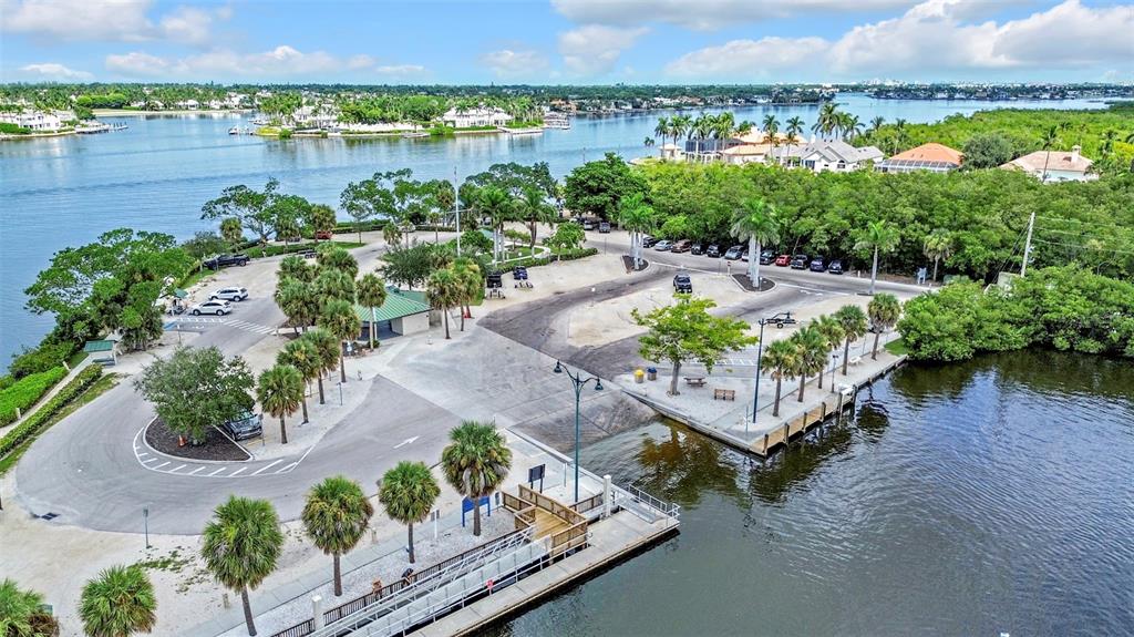 This aerial view shows a coastal neighborhood with a marina, mangrove forests, and open water — 1931 DANFORD STREET, NAPLES, FL