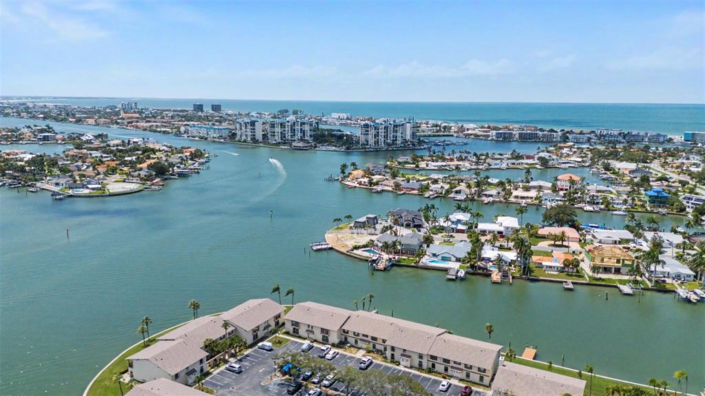An aerial view of a waterfront residential neighborhood with multi-story buildings and boat docks — 519 PLAZA SEVILLE COURT UNIT 39, TREASURE ISLAND, FL
