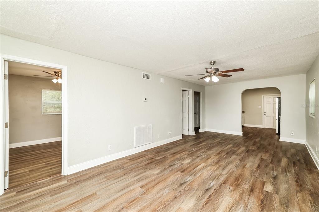 An interior view of a living room with light gray walls and wood-look flooring — 2624 13TH AVENUE S, ST PETERSBURG, FL