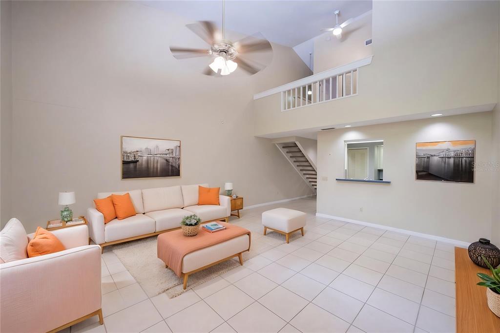 A living room with tile flooring, a vaulted ceiling, a loft, and a staircase — 499 CLUB DRIVE, WINTER SPRINGS, FL