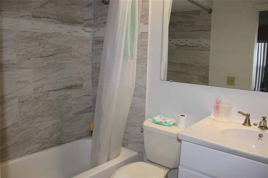A room with gray carpet, a ceiling fan, a treadmill, and a weight bench — 6121 56TH AVENUE N, ST PETERSBURG, FL
