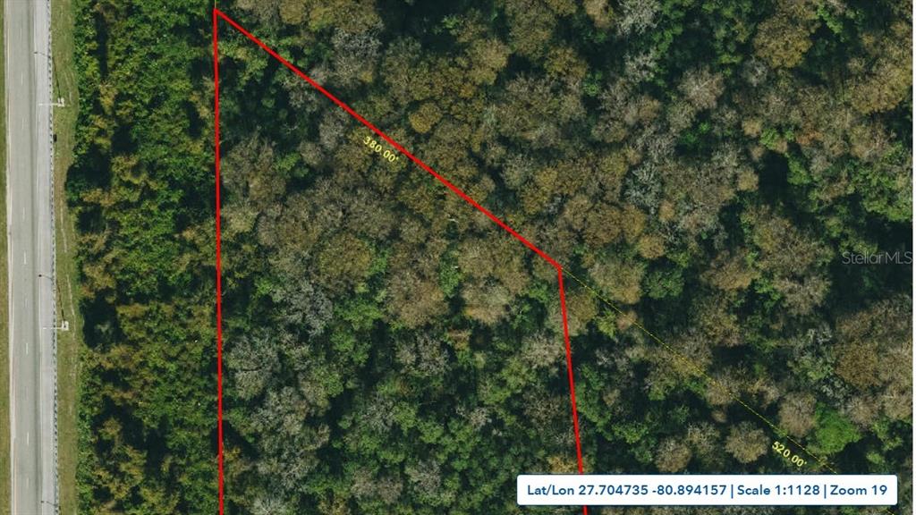An aerial map shows a wooded, triangular-shaped plot of land adjacent to a highway — 0 PALM AVENUE, OKEECHOBEE, FL