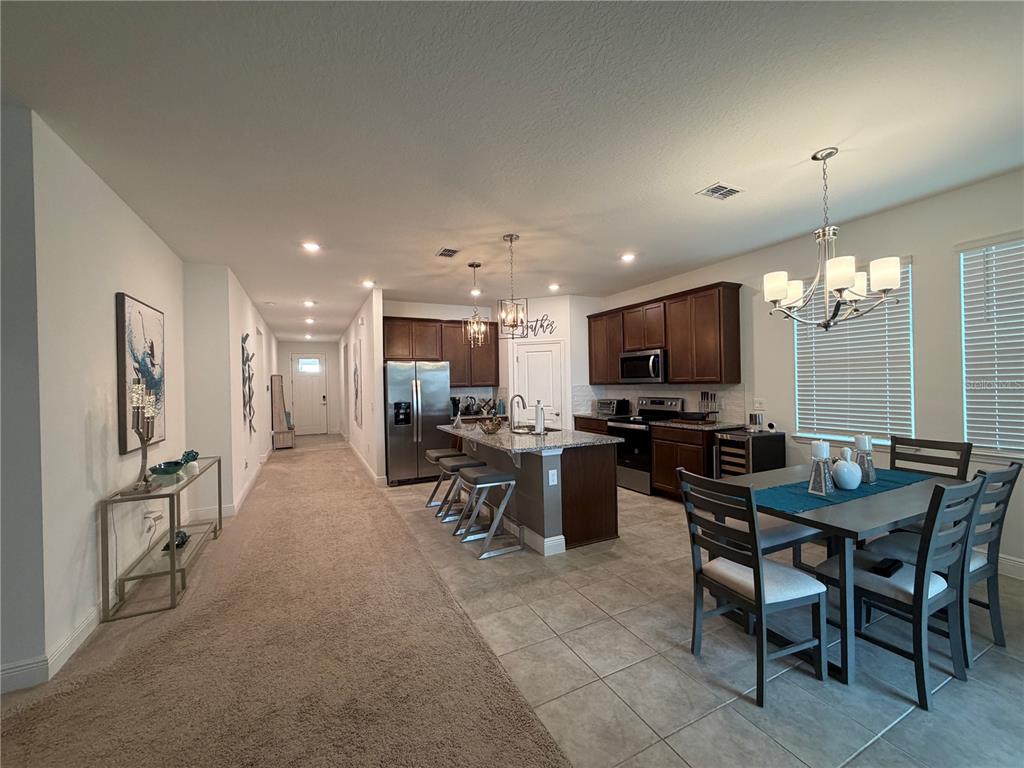 An aerial view shows a single-family home with a paved driveway and fenced backyard — 2312 CROSSBOW STREET, CLERMONT, FL