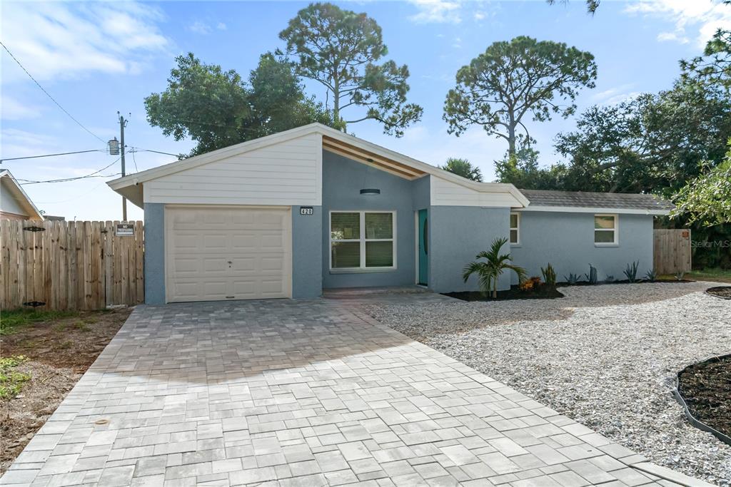 A single-story house with a blue stucco exterior, a paved driveway, and a garage — 420 MELODY CIRCLE, SARASOTA, FL