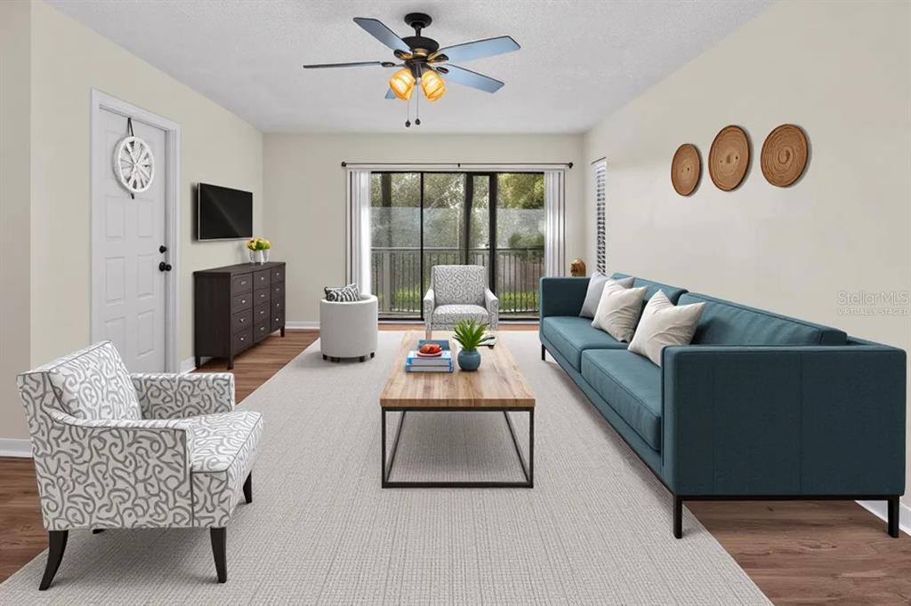 A screened-in balcony with a dark floor, white walls, and sliding glass doors — 1127 PINE RIDGE CIRCLE W UNIT A2, TARPON SPRINGS, FL