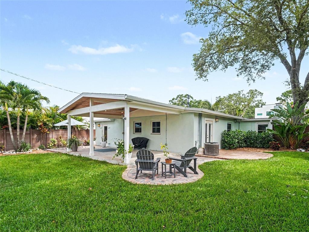 A single-story house with a paved driveway, palm tree, and large oak tree in front — 2344 TEMPLE STREET, SARASOTA, FL