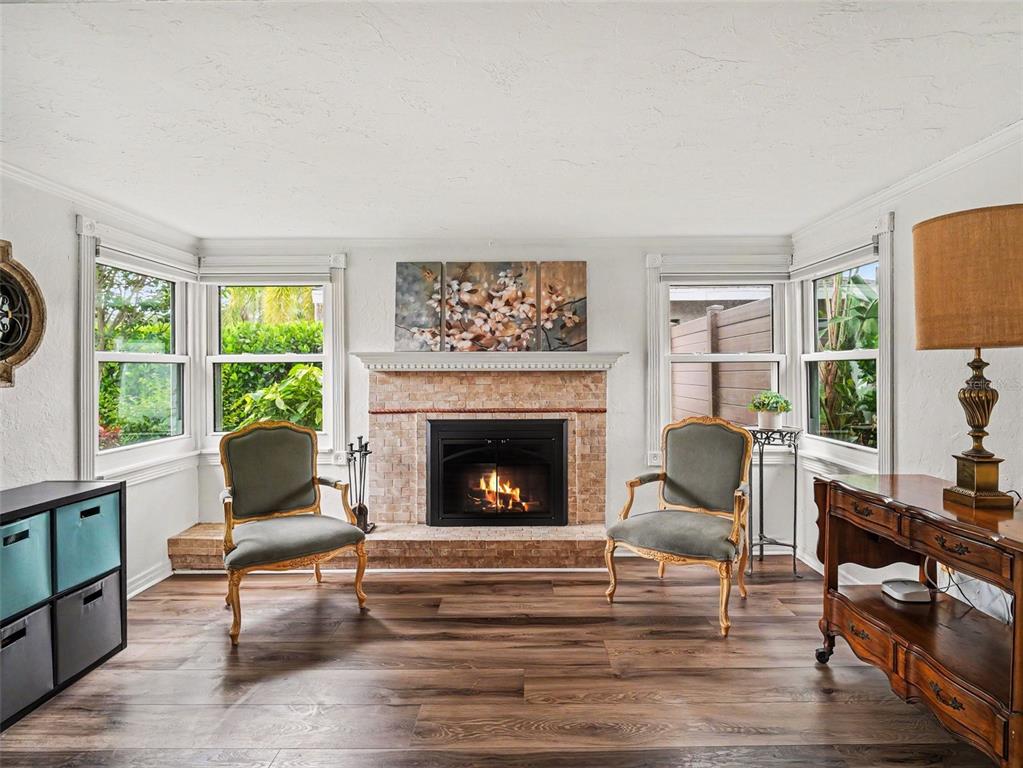 A patio features a covered seating area, a dining set with an umbrella, and landscaping — 2344 TEMPLE STREET, SARASOTA, FL