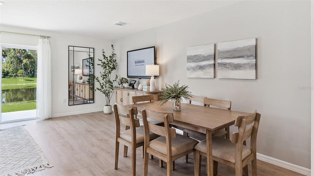 A dining room features a wooden table, six chairs, a sideboard, and a sliding glass door — 793 PRESTON COVE DRIVE, ST CLOUD, FL