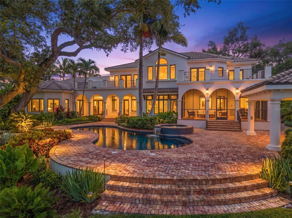 A two-story Mediterranean-style house features a brick patio, a swimming pool, and a hot tub — 3000 SOUTHWEST DRIVE, SARASOTA, FL