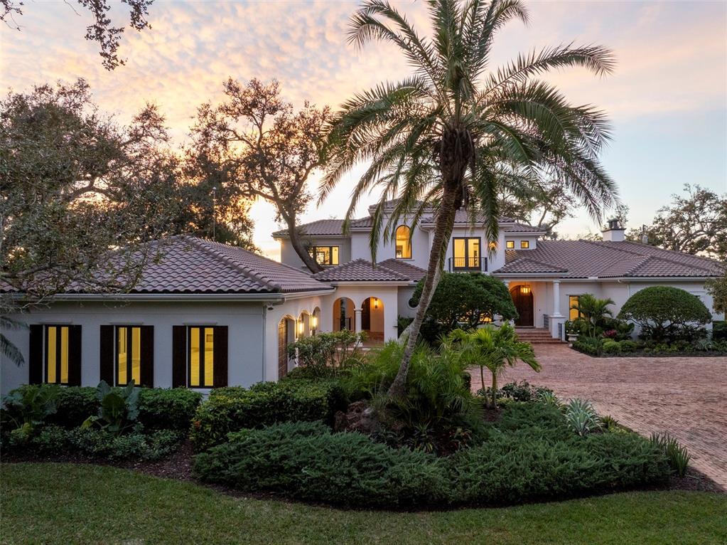 A large, two-story Mediterranean-style house with a tile roof, palm tree, and brick driveway — 3000 SOUTHWEST DRIVE, SARASOTA, FL