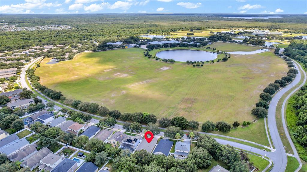 An aerial view shows a residential house marked with a red pin near a lake — 11513 MOSSY OAK DRIVE, ORLANDO, FL