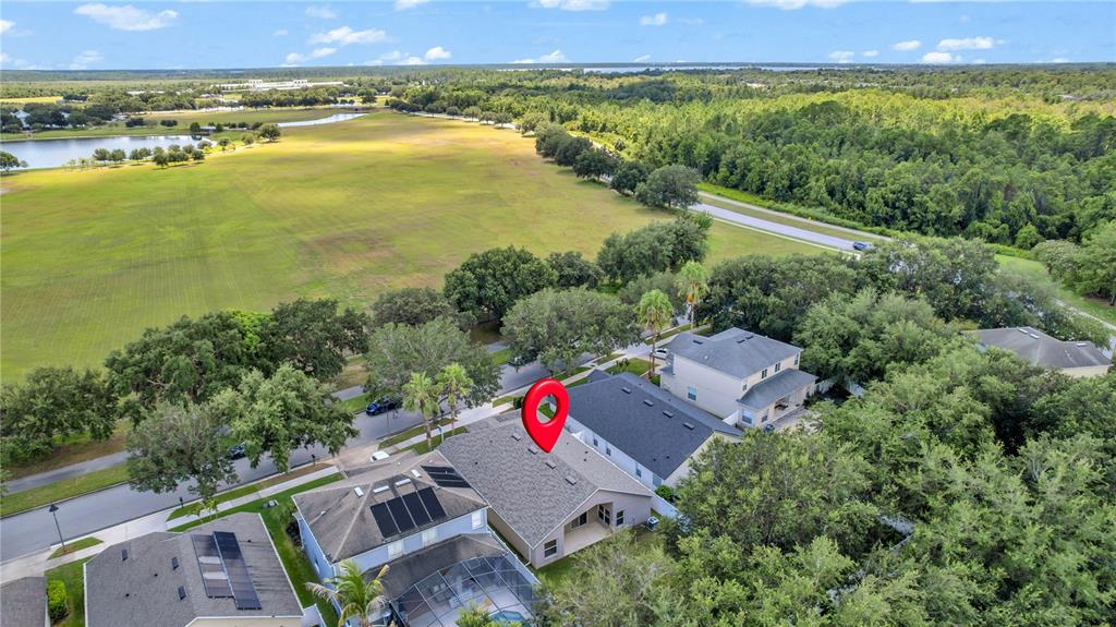 An aerial view shows a residential house with a red location pin on its roof — 11513 MOSSY OAK DRIVE, ORLANDO, FL