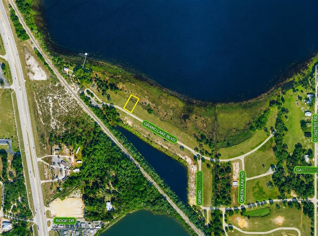 An aerial map view showing a highlighted property lot located near a large lake — 994 GRAND LAKE BOULEVARD, AVON PARK, FL