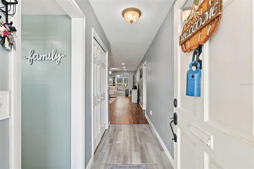 A breakfast nook with a wooden bench table set against a light blue accent wall — 1659 S LAKE AVENUE UNIT 1, CLEARWATER, FL