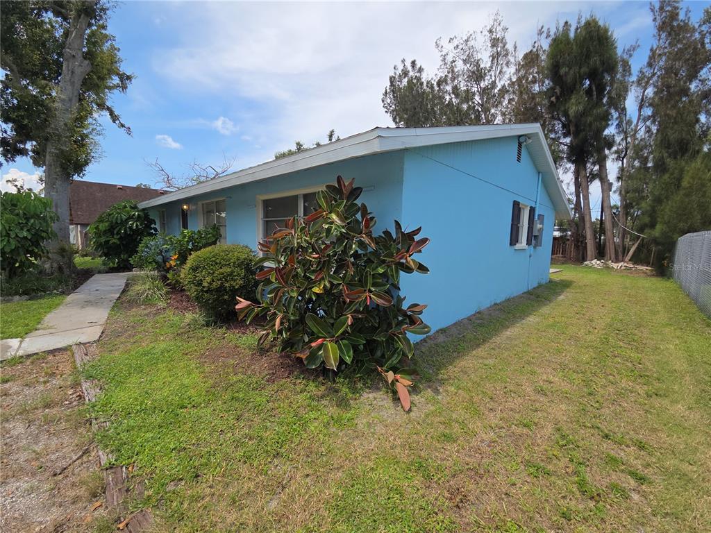 A light blue single-story house with a rubber plant in the front yard — 4136 S LOCKWOOD RIDGE ROAD, SARASOTA, FL