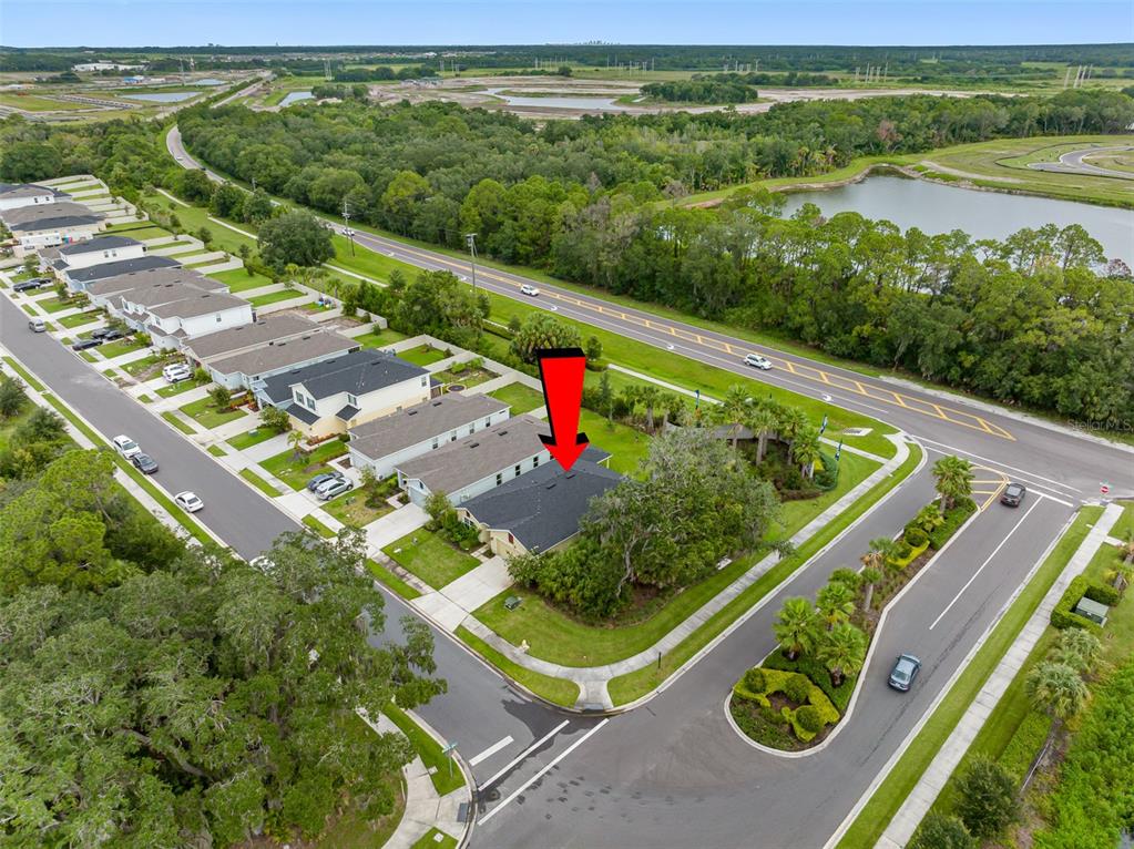 An aerial view shows a single-story house with a dark roof on a corner lot — 11234 HIGH NOON TRAIL, PARRISH, FL
