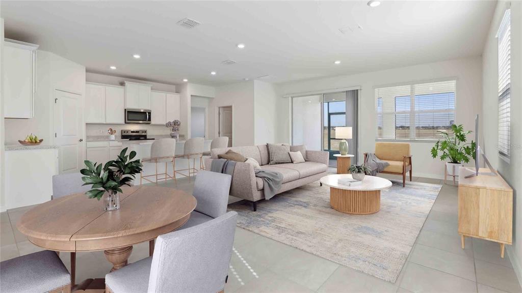 This is a digital rendering of an open-concept living room, dining area, and kitchen — 3036 CANOPY OAK BOULEVARD, WILDWOOD, FL