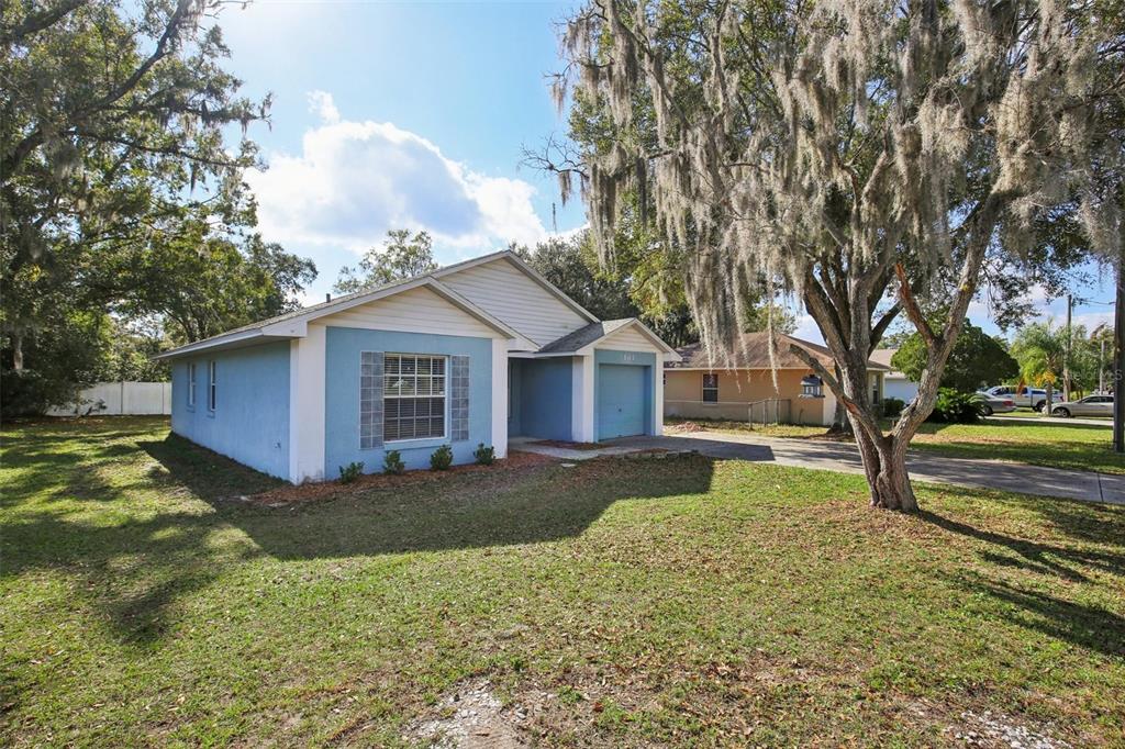 A single-story blue house with a white-trimmed window and a small attached garage — 3501 W REYNOLDS STREET, PLANT CITY, FL
