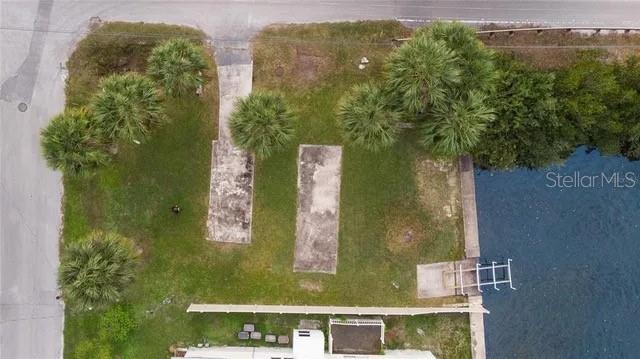 An aerial view shows a grassy lot with two concrete pads and a small boat dock — 6807 EDGEWATER DRIVE, NEW PORT RICHEY, FL