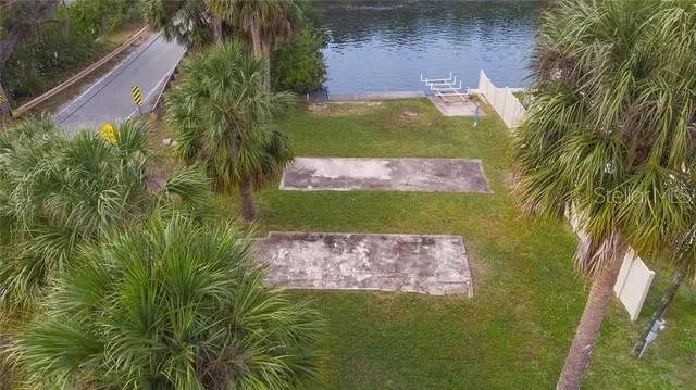 An aerial view shows a grassy lot with two concrete pads near a waterfront bulkhead — 6807 EDGEWATER DRIVE, NEW PORT RICHEY, FL